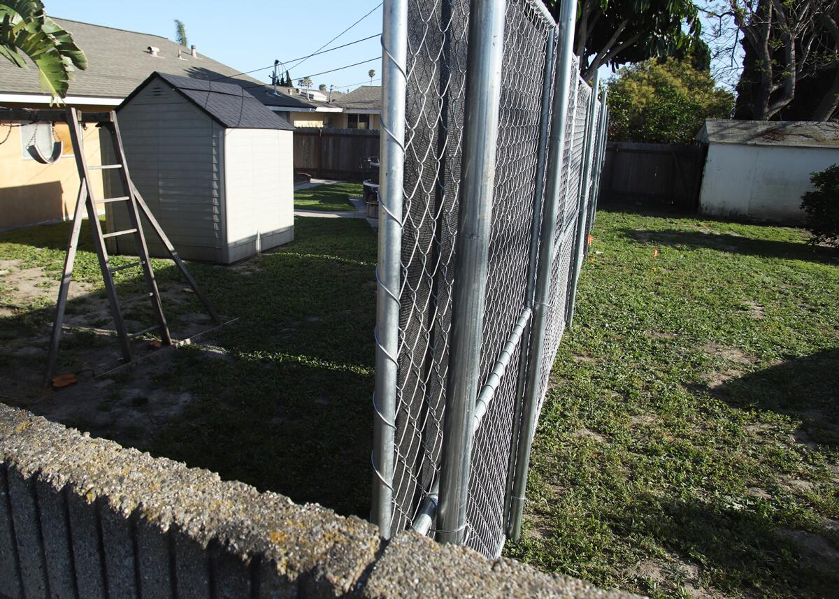 The O.C. Sanitation District placed a fence on Rhone Lane in Huntington Beach as it has begun an easement cleanup project.