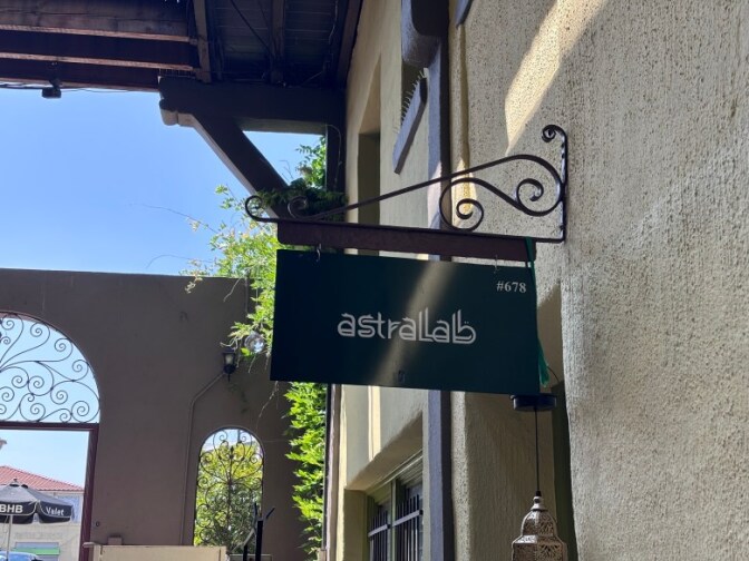 A sign in a courtyard that reads Astralab