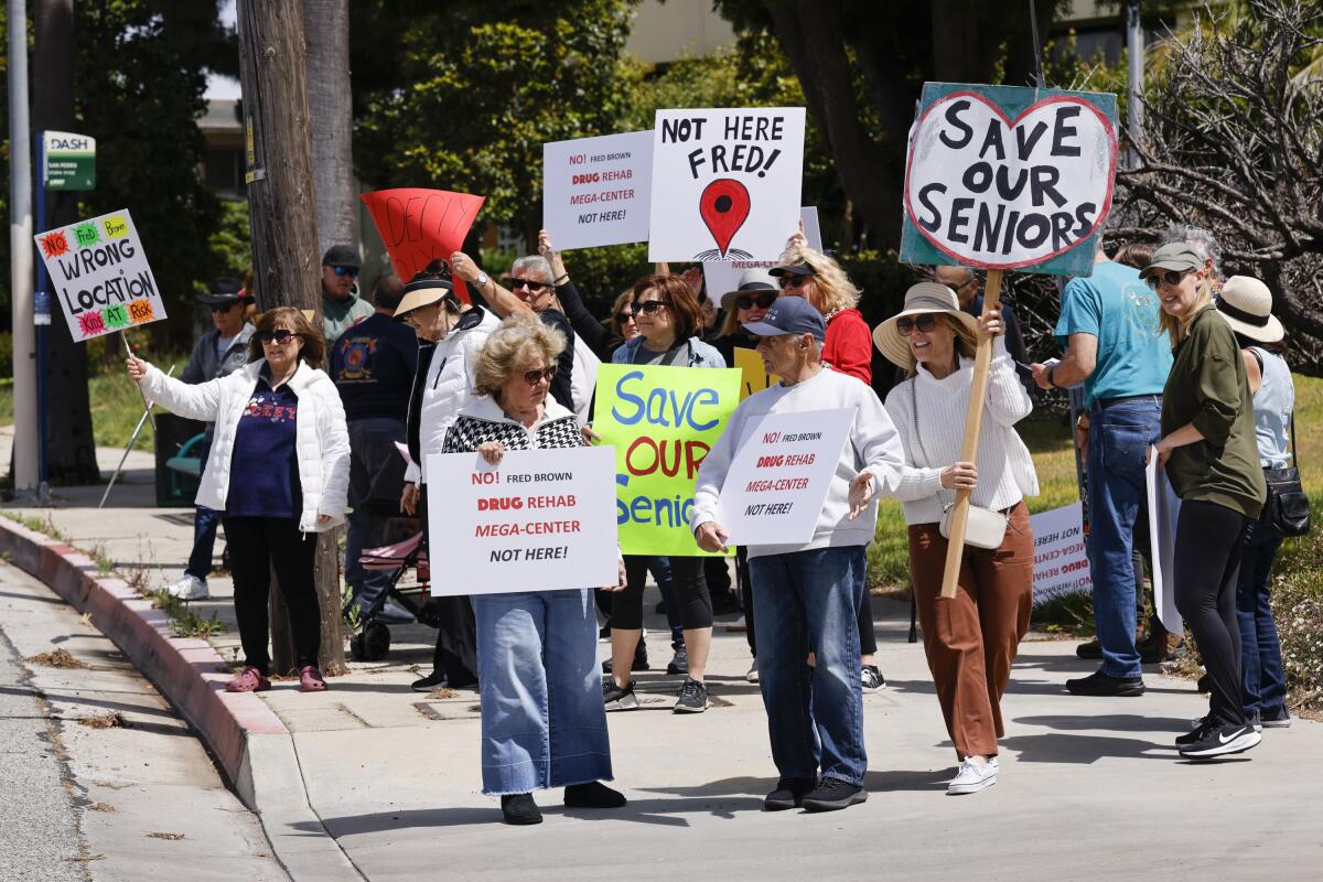 People demonstrate outside Ocean View Living to oppose a proposed drug rehabilitation facility