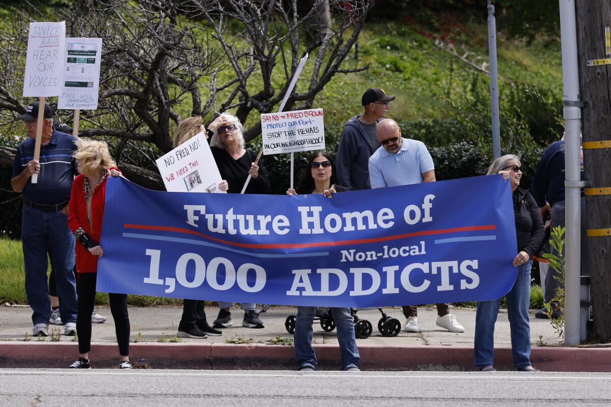 People demonstrate outside Ocean View Living to oppose a proposed drug rehabilitation facility