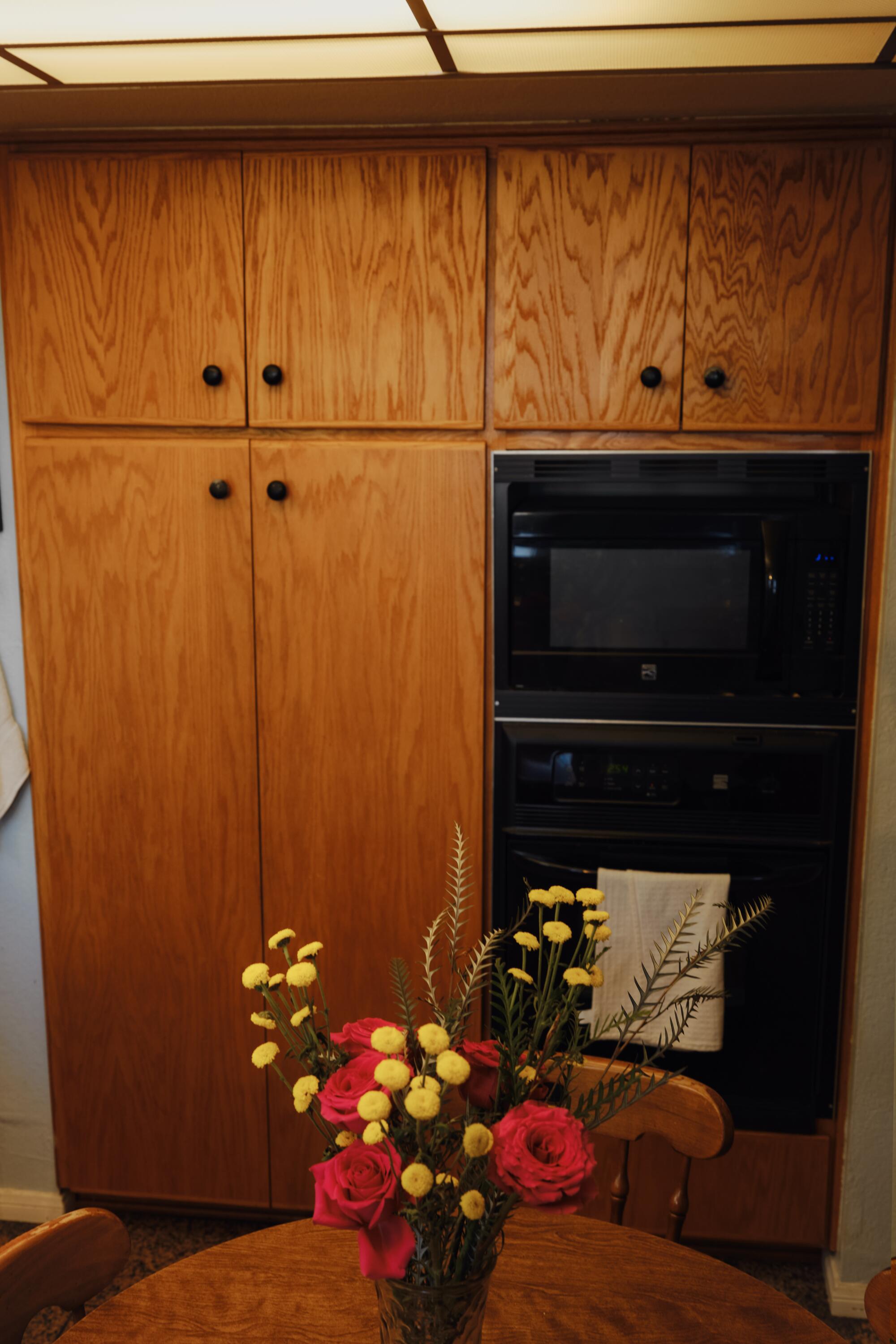 Wall cabinets, and double ovens inside Felema Ye's kitchen. 
