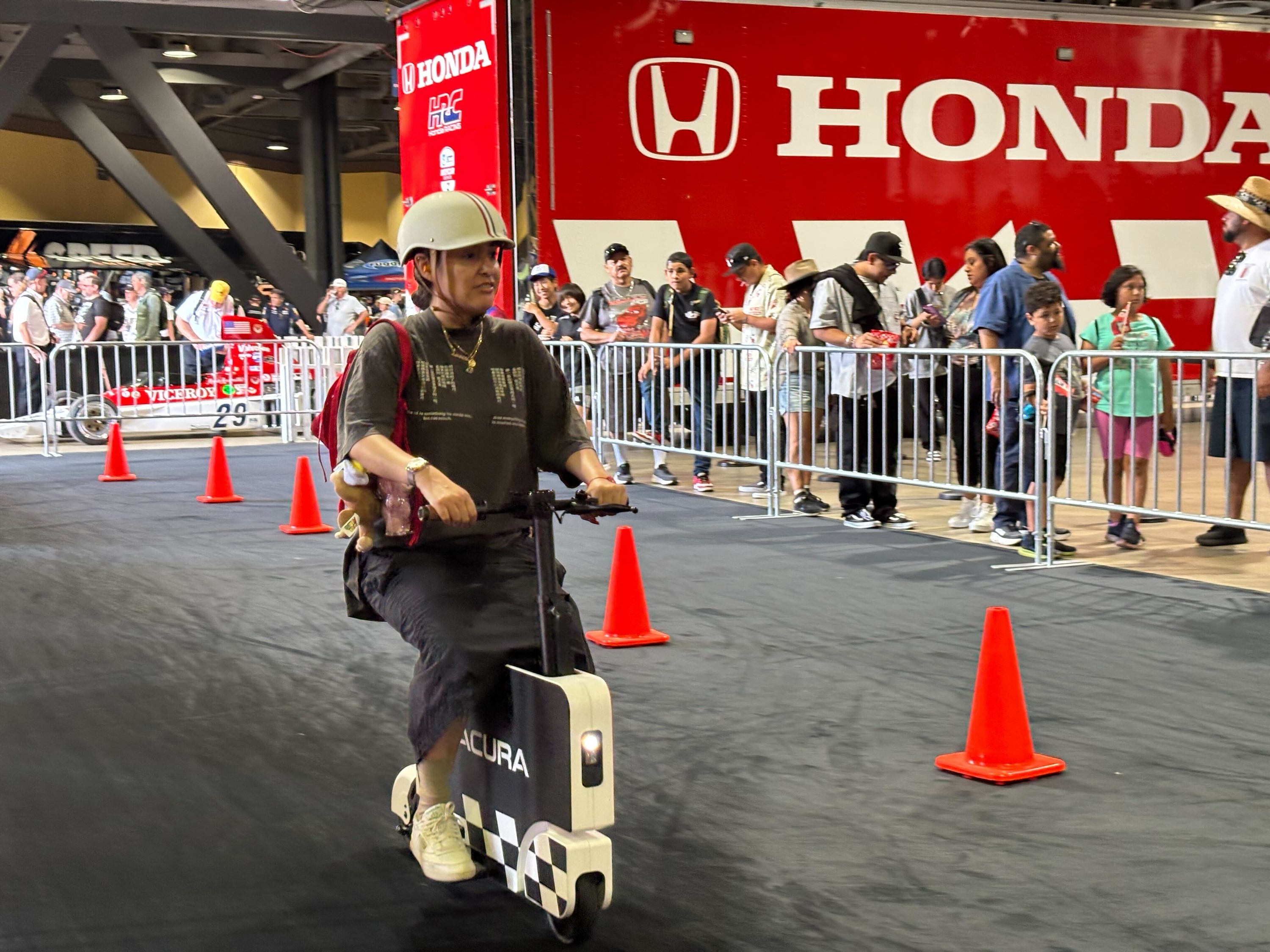 Dyanna Jimenez tries out the Honda Motocompacto e-scooters at the...