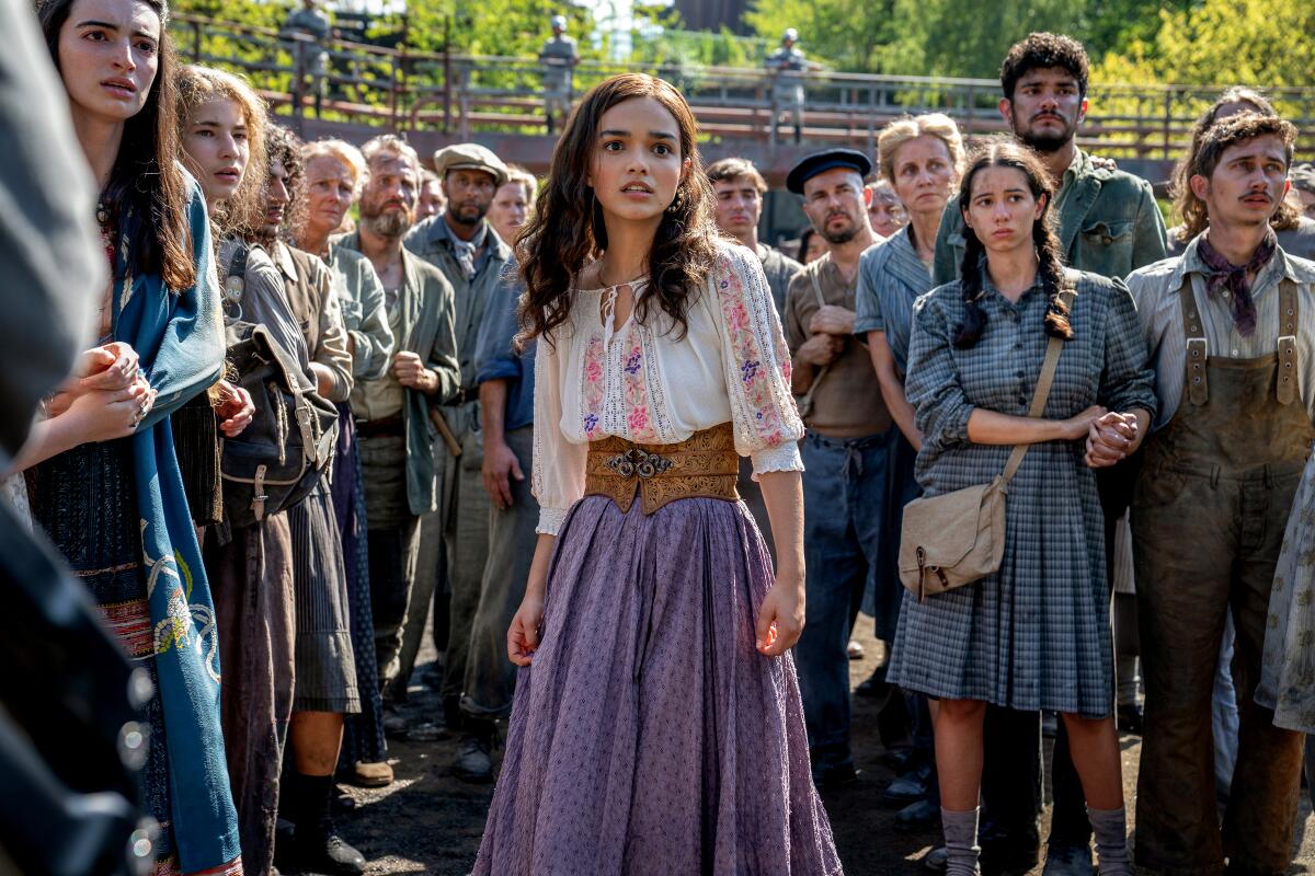 Teens gather outdoors in a still from the film "The Hunger Games: The Ballad of Songbirds and Snakes."