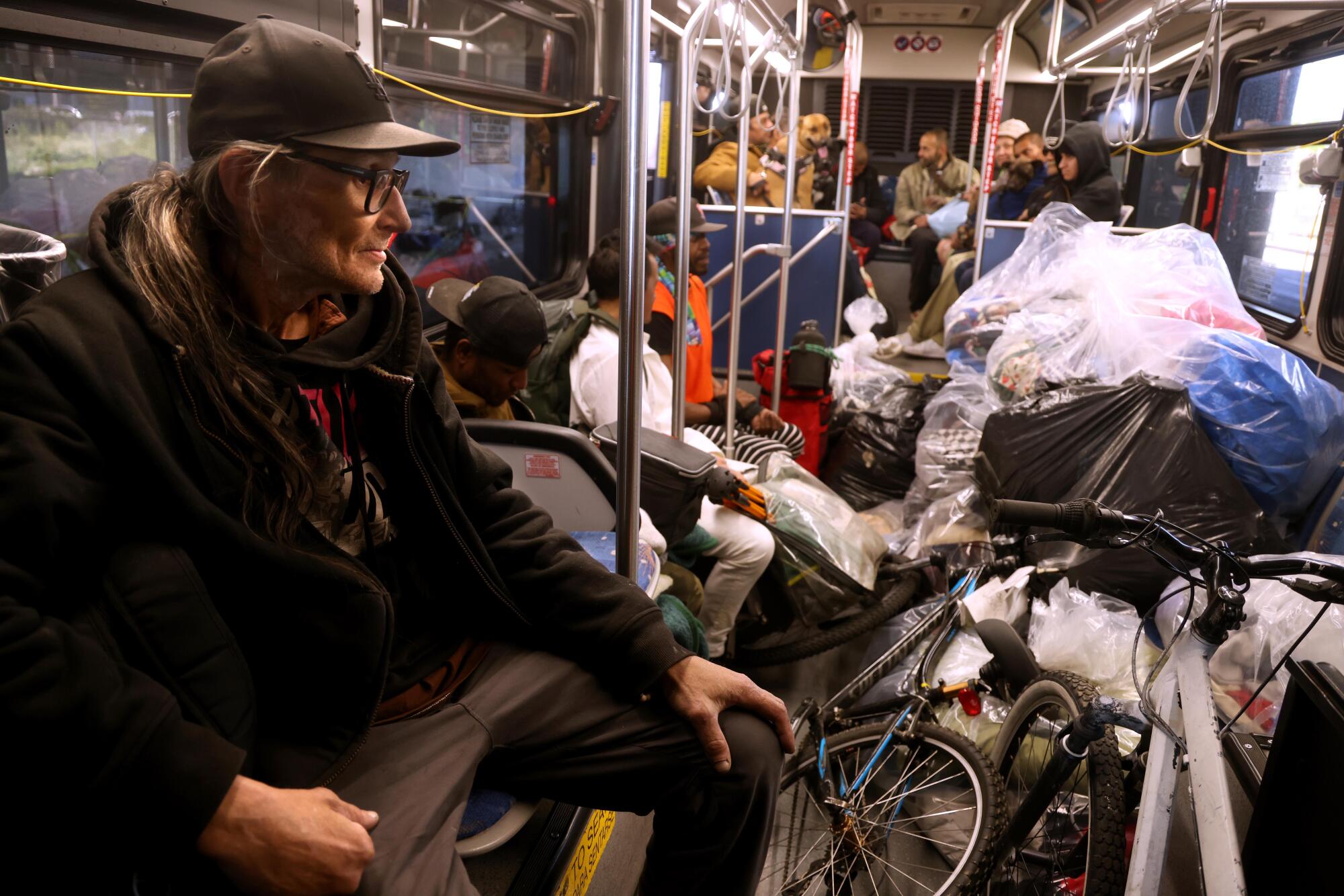 Andrew Steffens waits to be bused to interim housing provided by the Inside Safe program in North Hollywood.