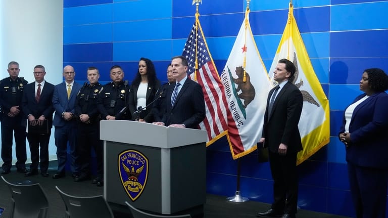 Craig Missakian, U.S. Attorney, Northern District of California, middle, speaks...