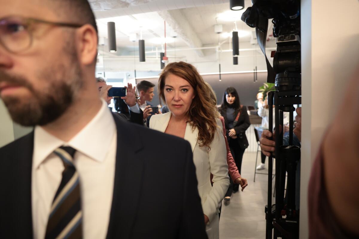 Lonna Drewes, walking behind her lawyer Arick Fudali