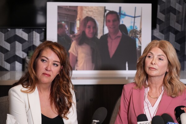 Lonna Drewes joins her lawyer Lisa Bloom at a news conference in Beverly Hills, Calif., Tuesday, April 14, 2026, to detail allegations of sexual misconduct by Rep. Eric Swalwell, after Swalwell exited the California governor's race and said he'll resign his seat in Congress.  The AP typically does not identify people who say they are victims of sexual assault unless they identify themselves publicly. (AP Photo/Damian Dovarganes)