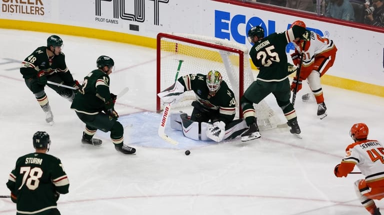 Minnesota Wild's Jesper Wallstedt (30) defends the net against the...