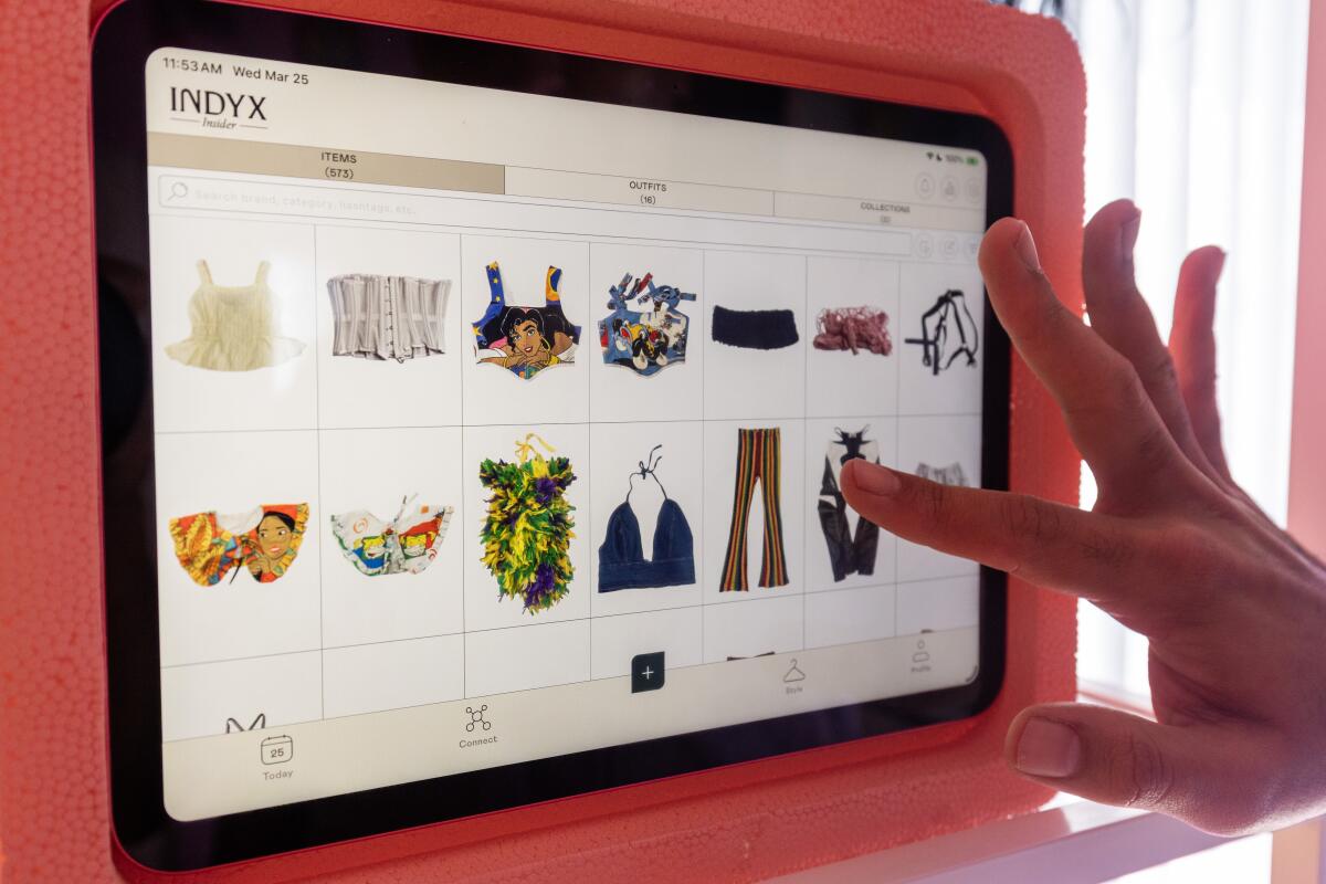 Brandon Shahniani searches his digital closet for outfits which are searchable on this iPad. 