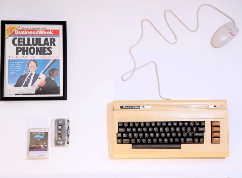 Cassette tapes, a keyboard and a Business Week magazine on Cellular phones 