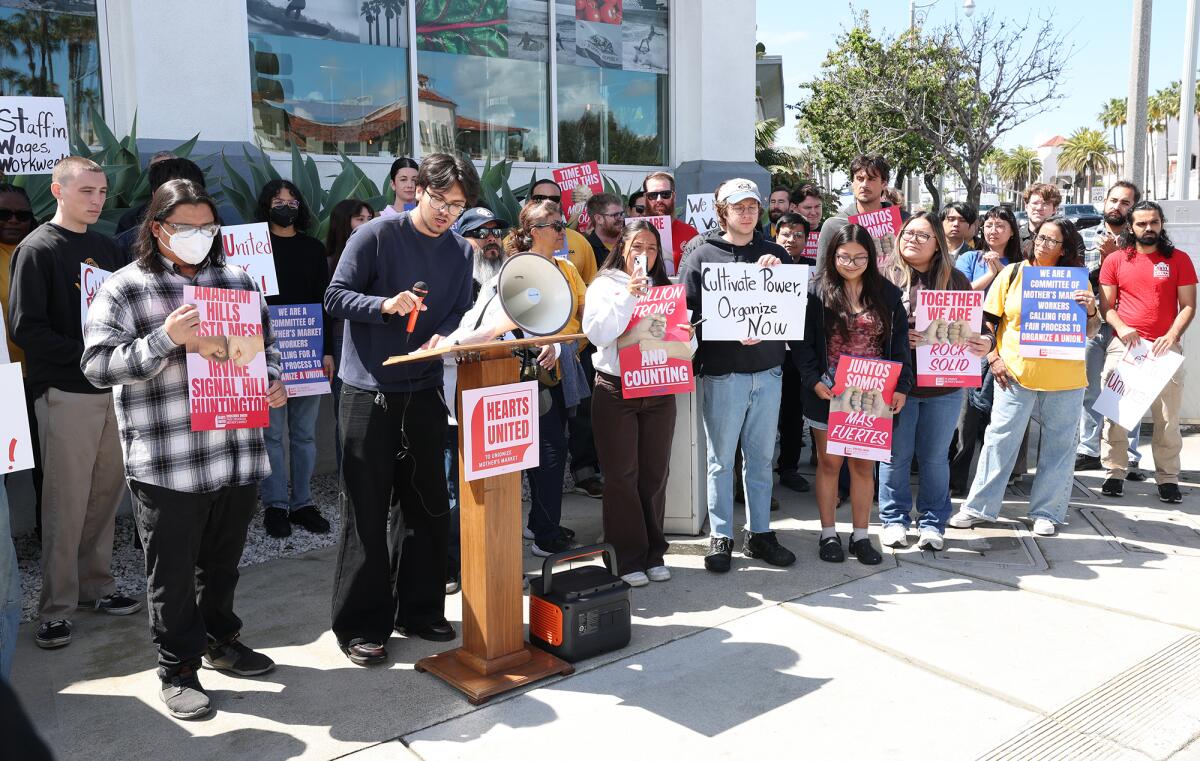 Grocery workers participate in a "March on the Boss" rally into Mother's Market on Newport Blvd and 19th St. in Costa Mesa.