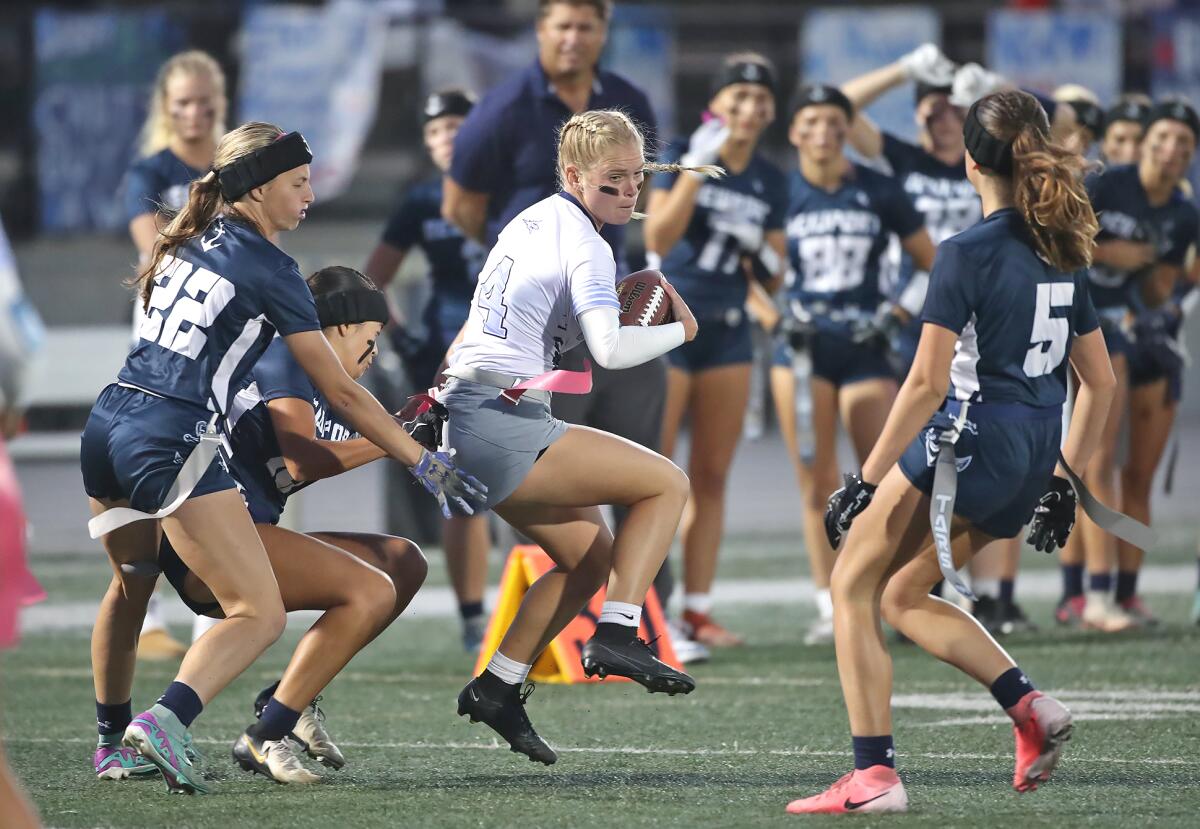 Corona del Mar's Alexa Rokos (4) eludes tacklers with a spin move.