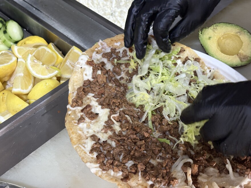 A La Villita worker prepares an asada quesadilla on March 31, 2026.