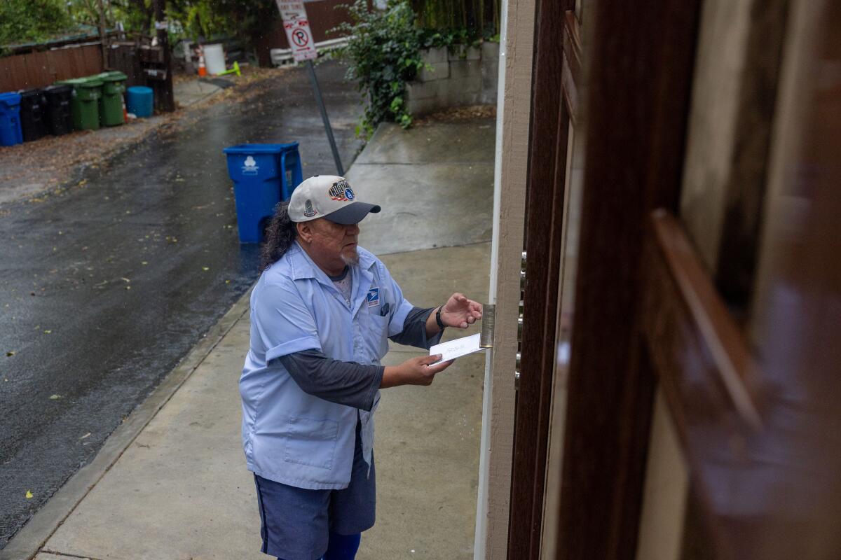 John Ayala delivers mail to a home.