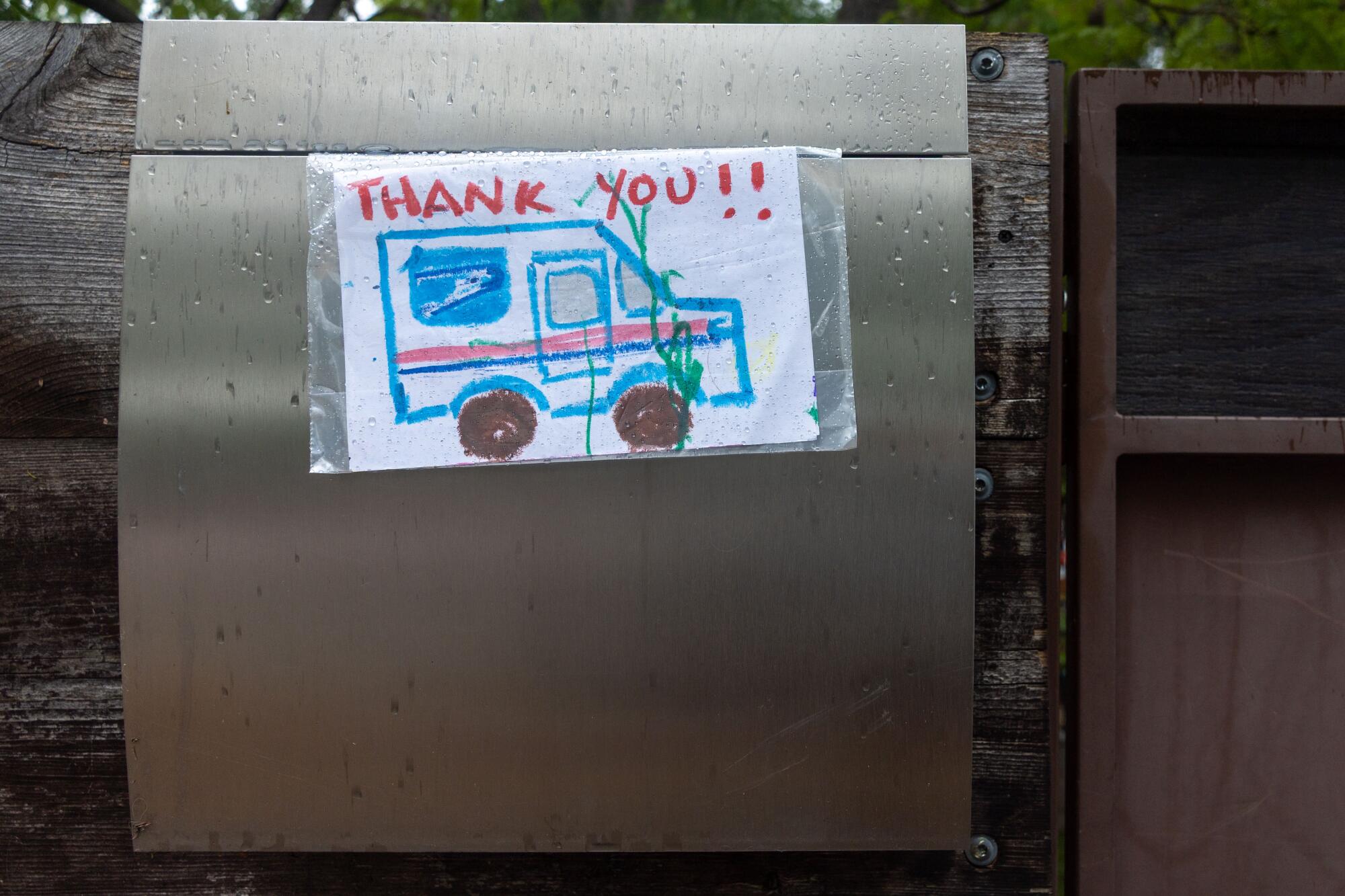 A hand-drawn thank you card taped to a mailbox on Ayala's route.