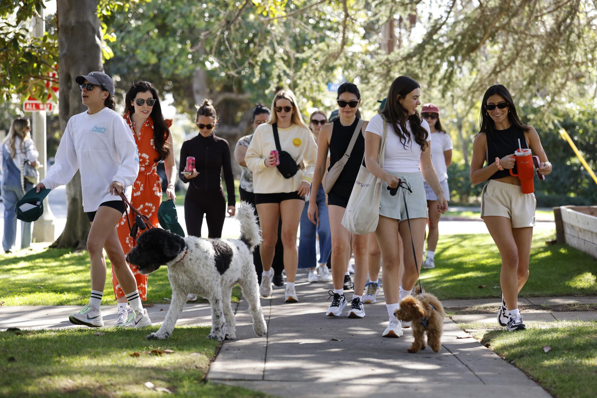 The Preoccupied book club makes their way through a Santa Monica neighborhood on Saturday, Jan. 31, 2026