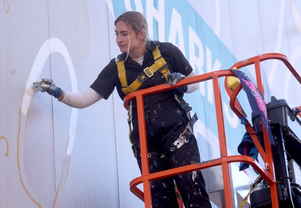 Artist Julie Engelmann, of Half Moon Bay, works on her mural of Olympic gold medal figure skaters Alysa Liu and Kristi Yamaguchi at the Oakland Ice Centerin Oakland, Calif., on Tuesday, April 7, 2026. Engelmann has worked on the mural since late March and it will be done this week. (Jane Tyska/Bay Area News Group)