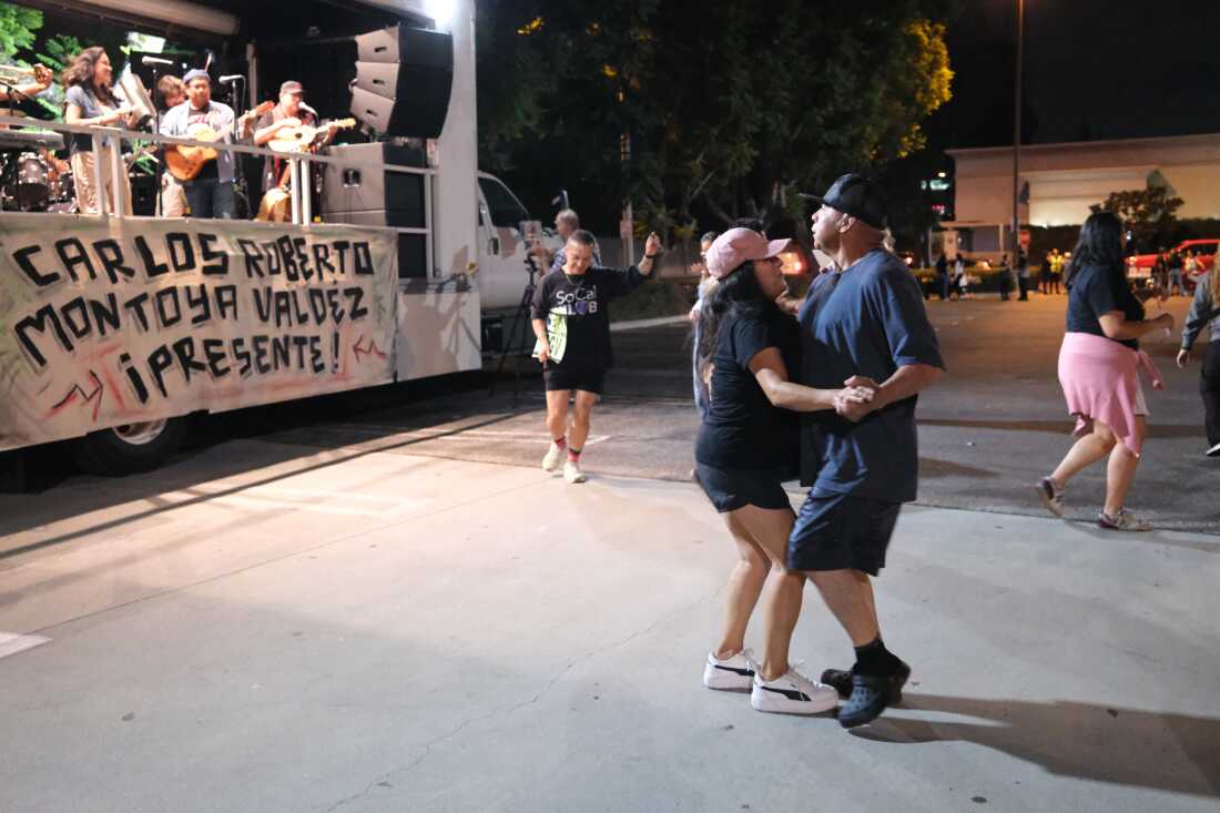 Dancing at an October memorial vigil for a day laborer who was hit by a car while trying to evade arrest by immigration agents.