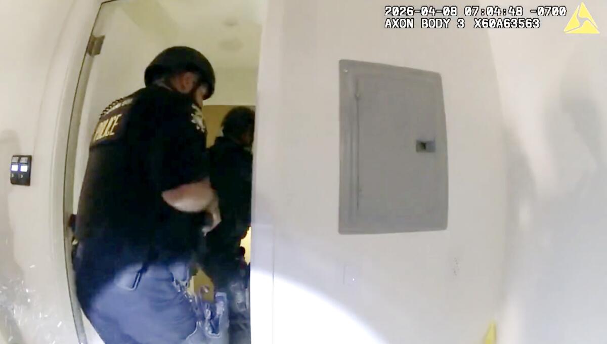 Law enforcement officers going through a doorway 