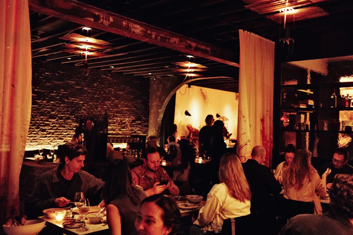 A low-lit interior of diners in Badmaash's Venice dining room