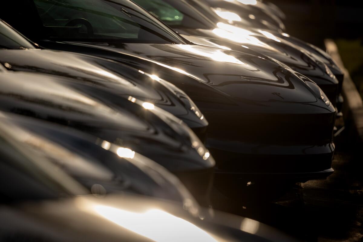 A Tesla dealership with cars lined up in the lot in Long Beach.