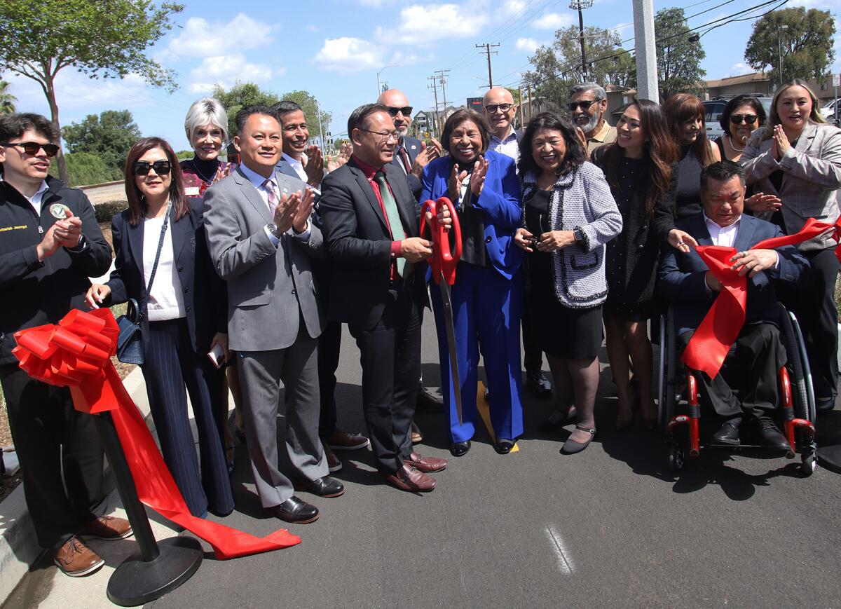 Sylvia Mendez, center, with sister Sandra Mendez Duran and Westminster Mayor Chi Charlie Nguyen, left, pose with dignitaries.