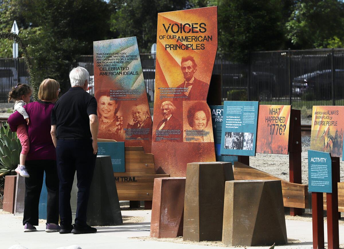 Guests read educational panels featured in the Mendez Freedom Trail along Hoover Street in Westminster.