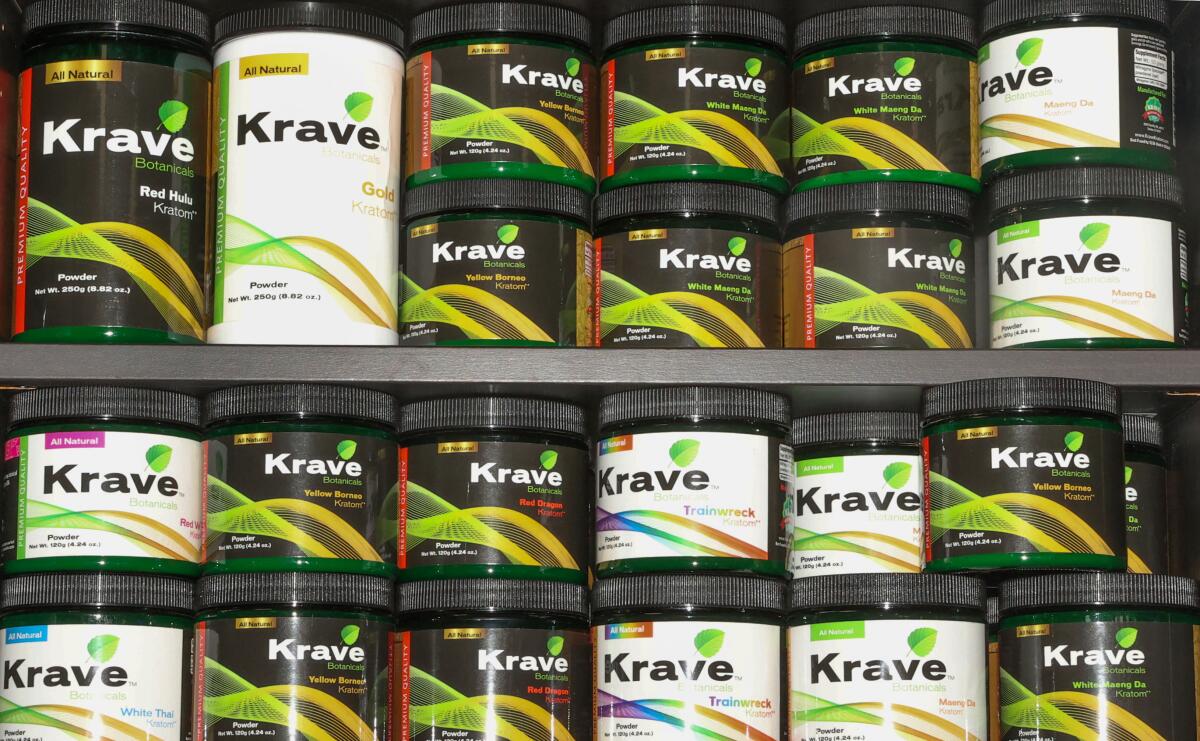 Kratom powder products are displayed at a smoke shop.
