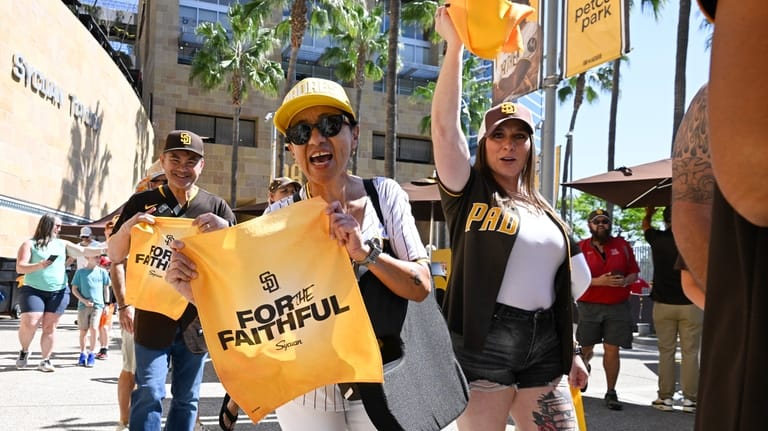 Fans cheer as they arrive at Petco Park for an...