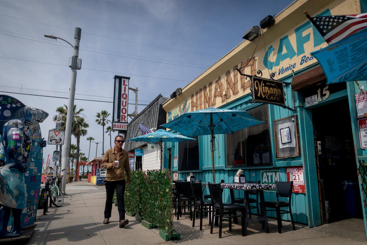A man walks past Hinano Cafe in Venice Beach.