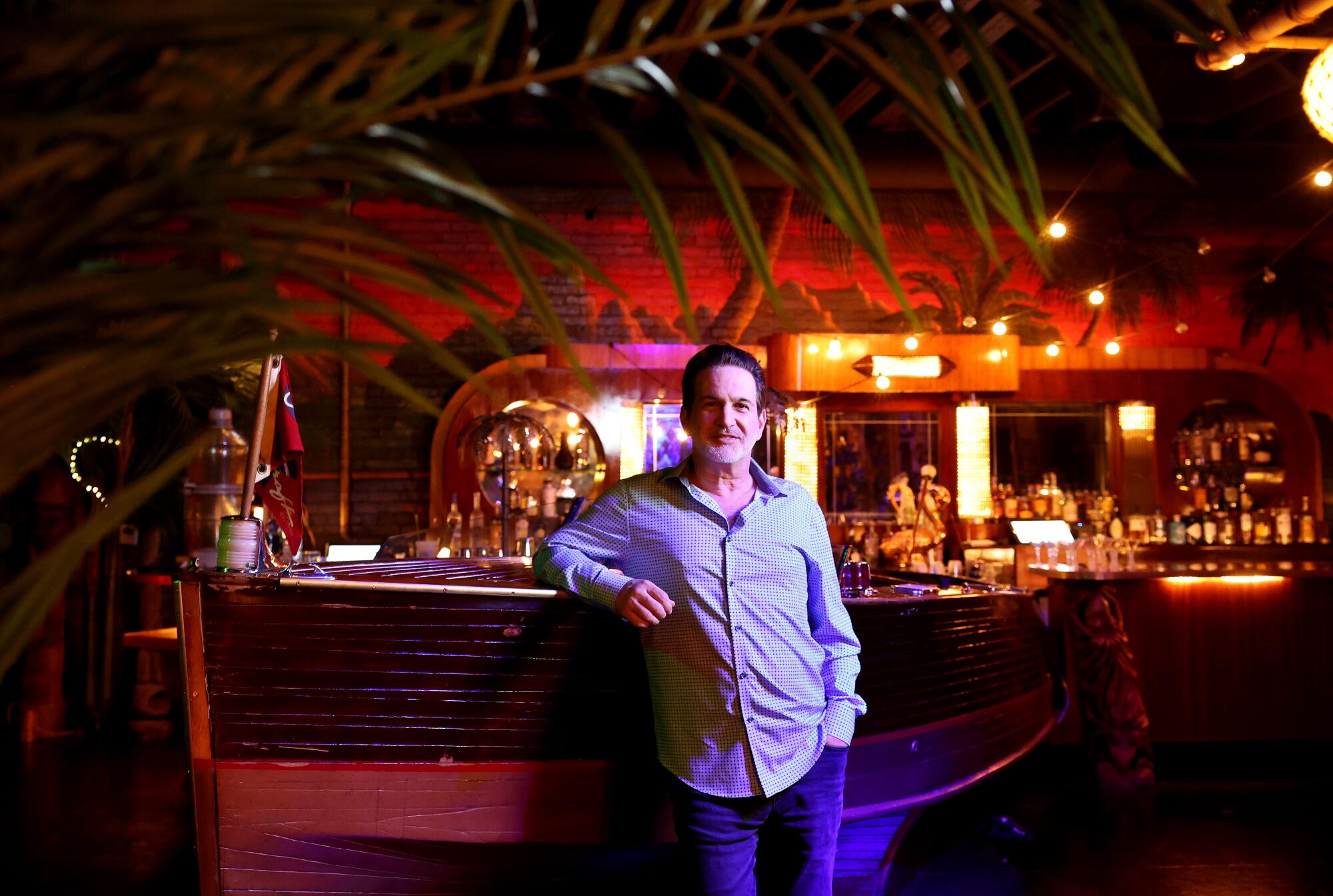 Clifton's Republic owner Andrew Meieran stands next to a boat on the top floor of the historic restaurant in 2024.