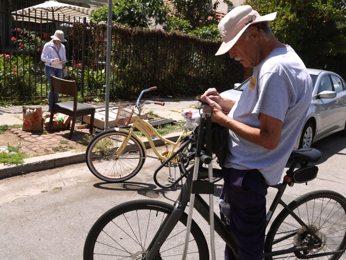 Sabine Phillips, 66, and Keith Johnson, 71, right, ride their bikes documenting debris left on sidewalks.
