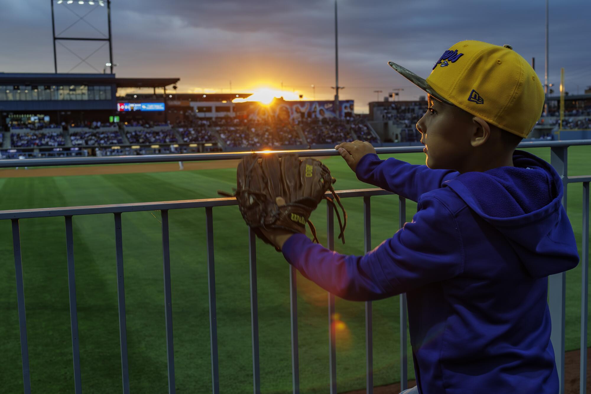 Rome Ruelas, 7, of Chino waits on the right-field railing for a home run ball on opening day.