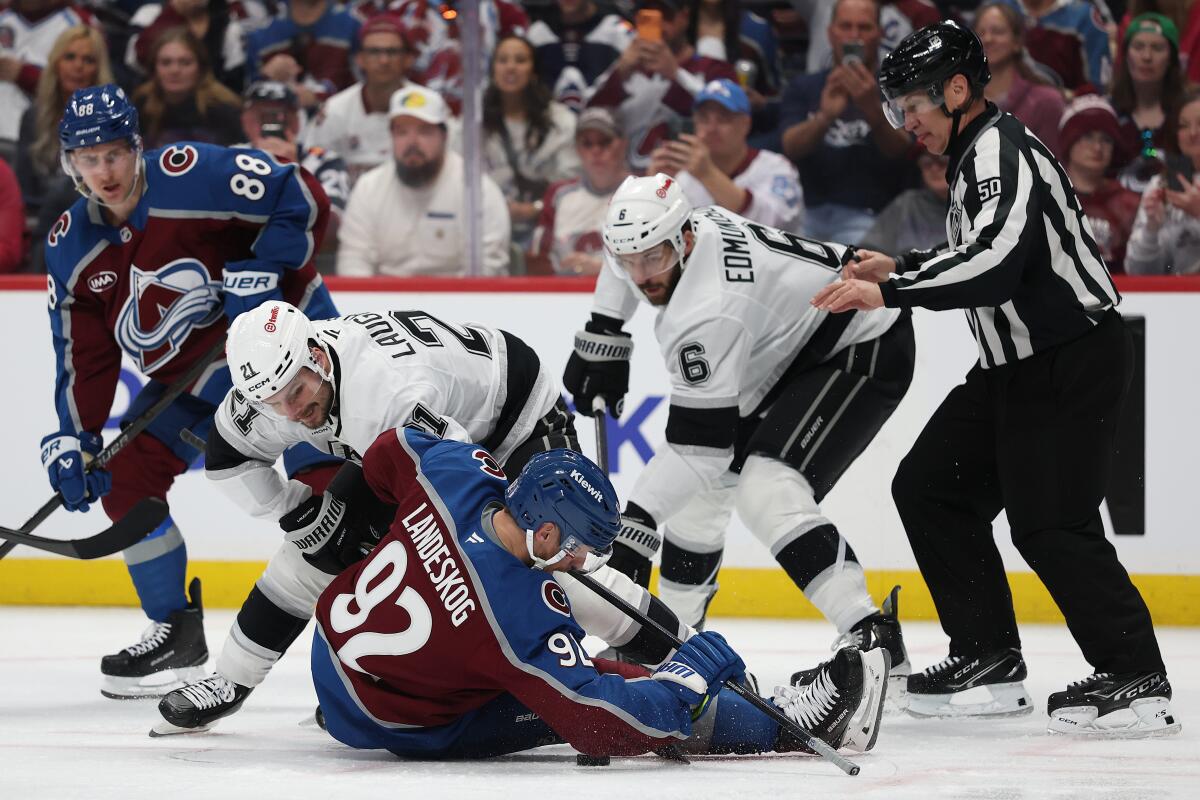 Gabriel Landeskog of the Avalanche fights for the puck against Scott Laughton and Joel Edmundson of the Kings.