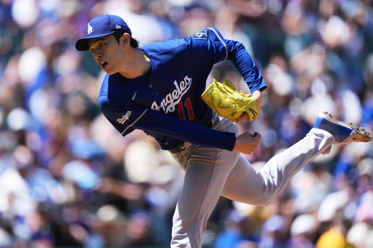 Dodgers starting pitcher Roki Sasaki follows through on a throw during a game in Denver.