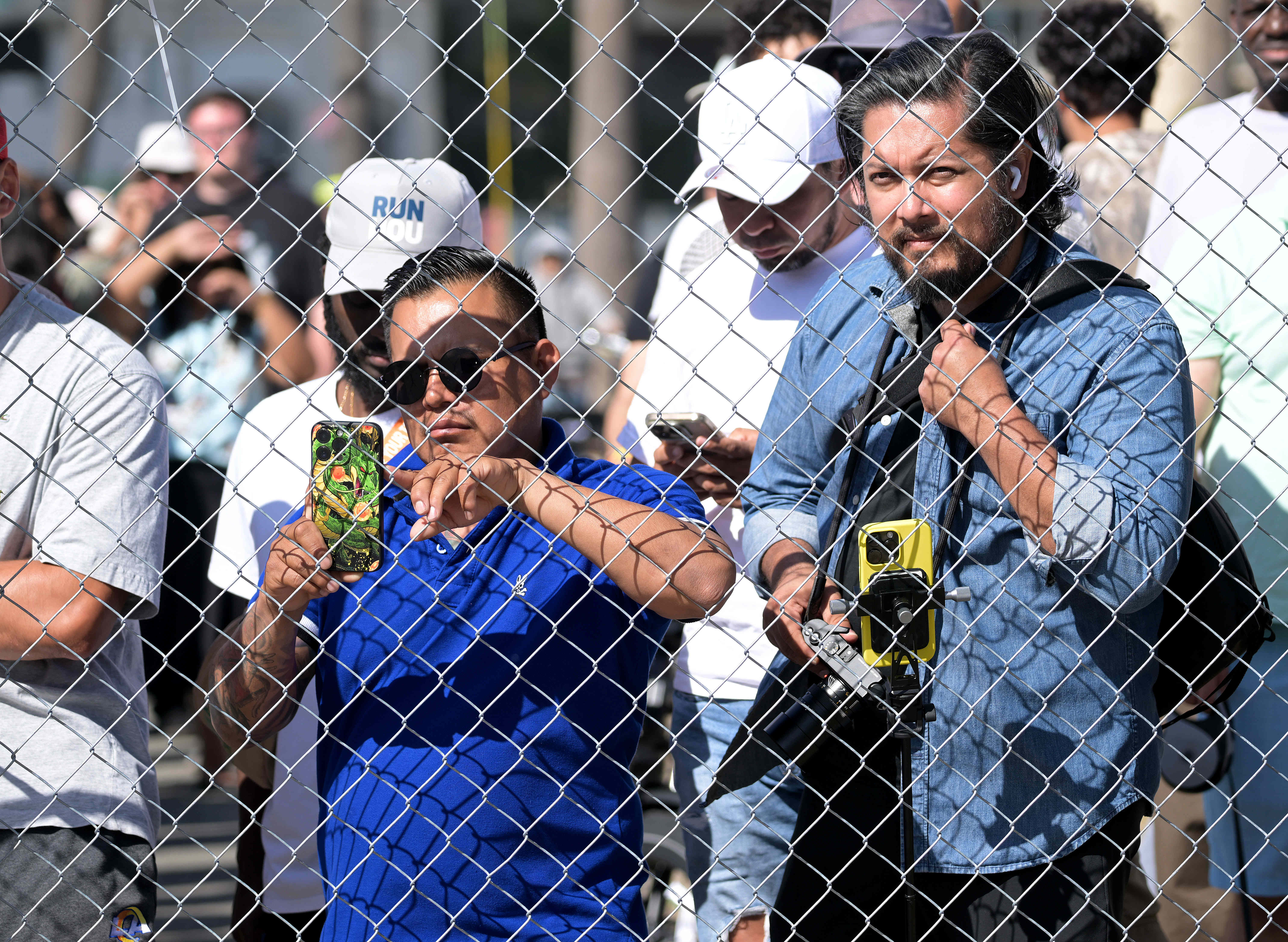 Race fans catch a glimpse of race cars in a...