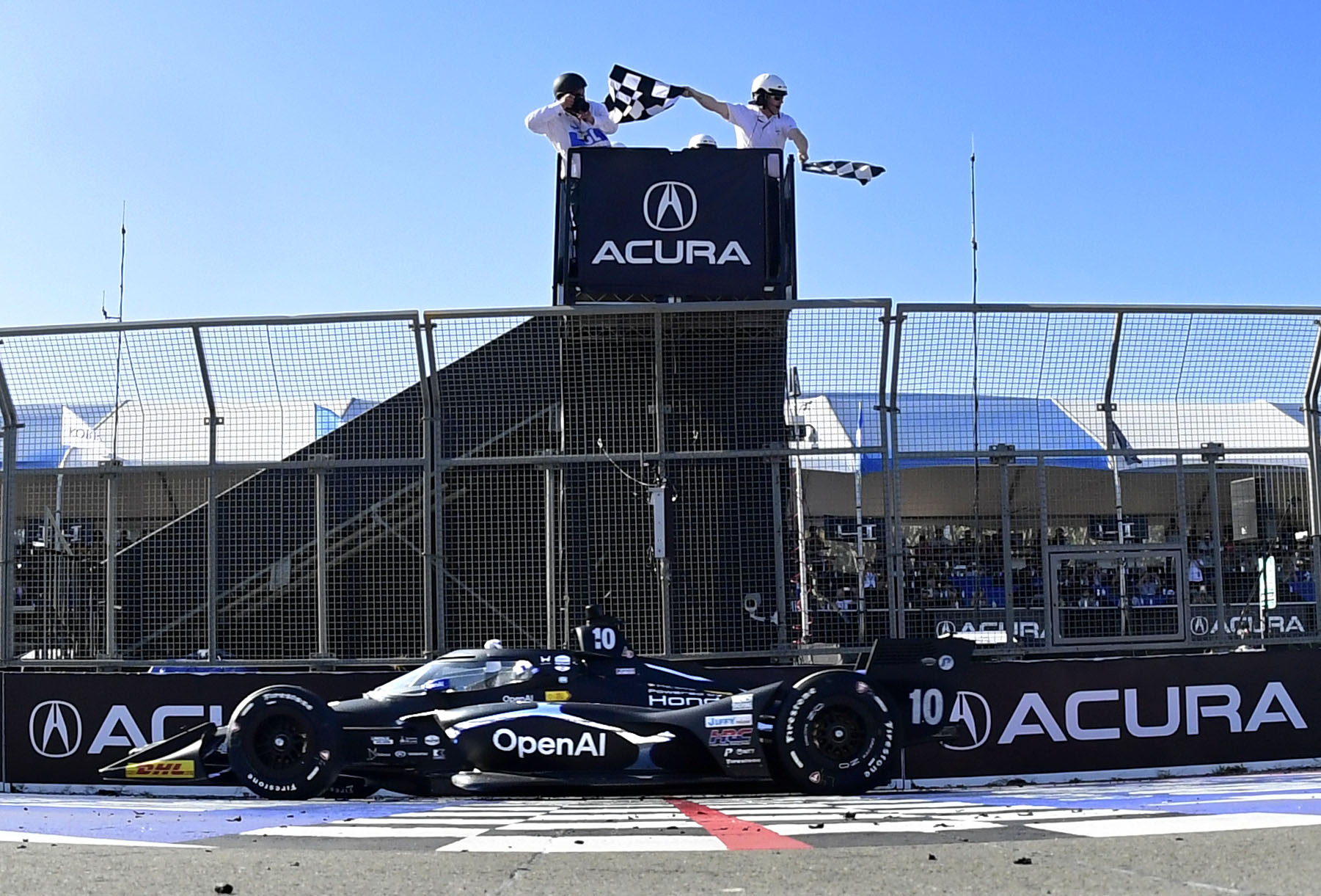 Indycar driver Alex Palou takes the checkered flag to win...