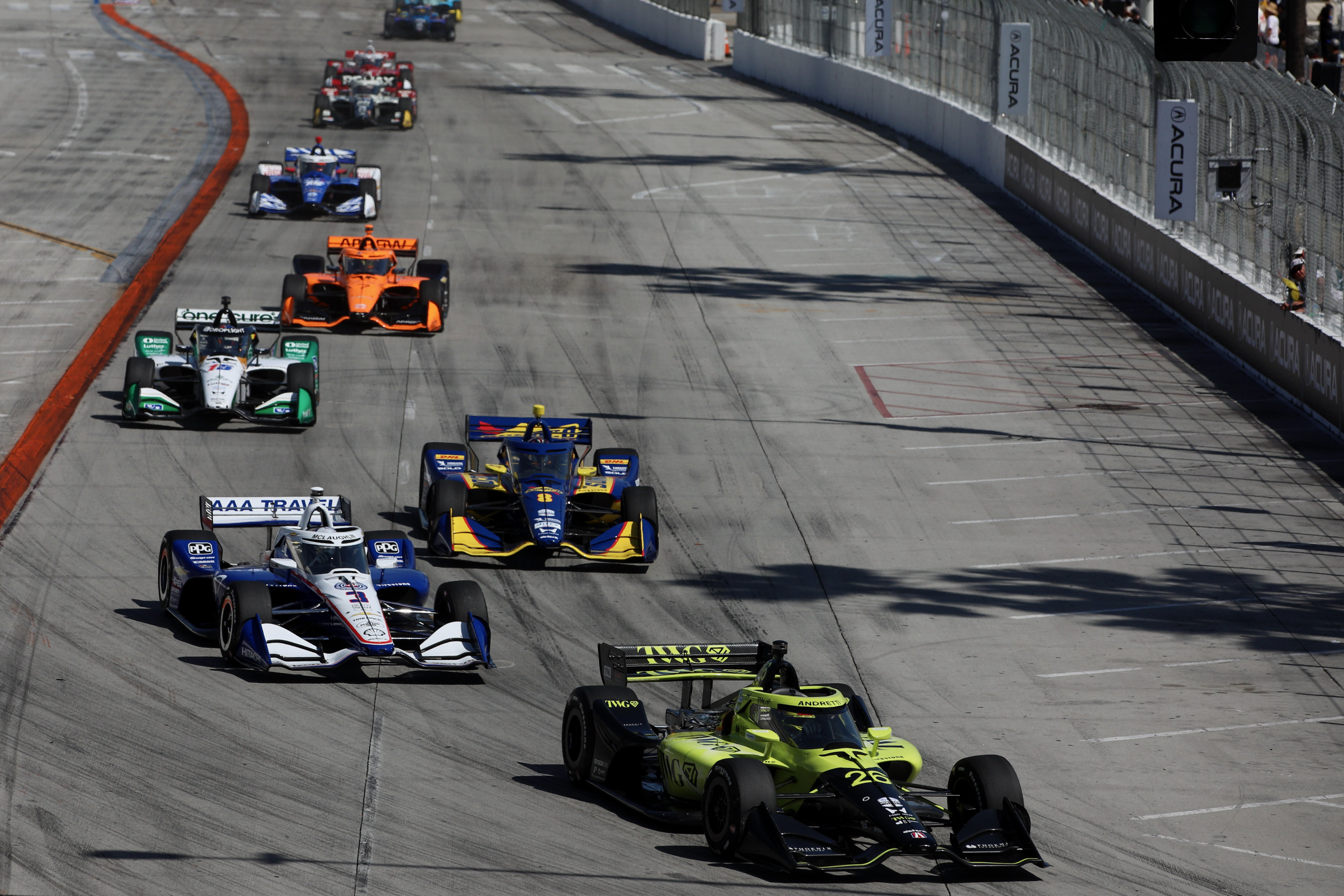 IndyCars approach the first turn off Shoreline Drive at the...