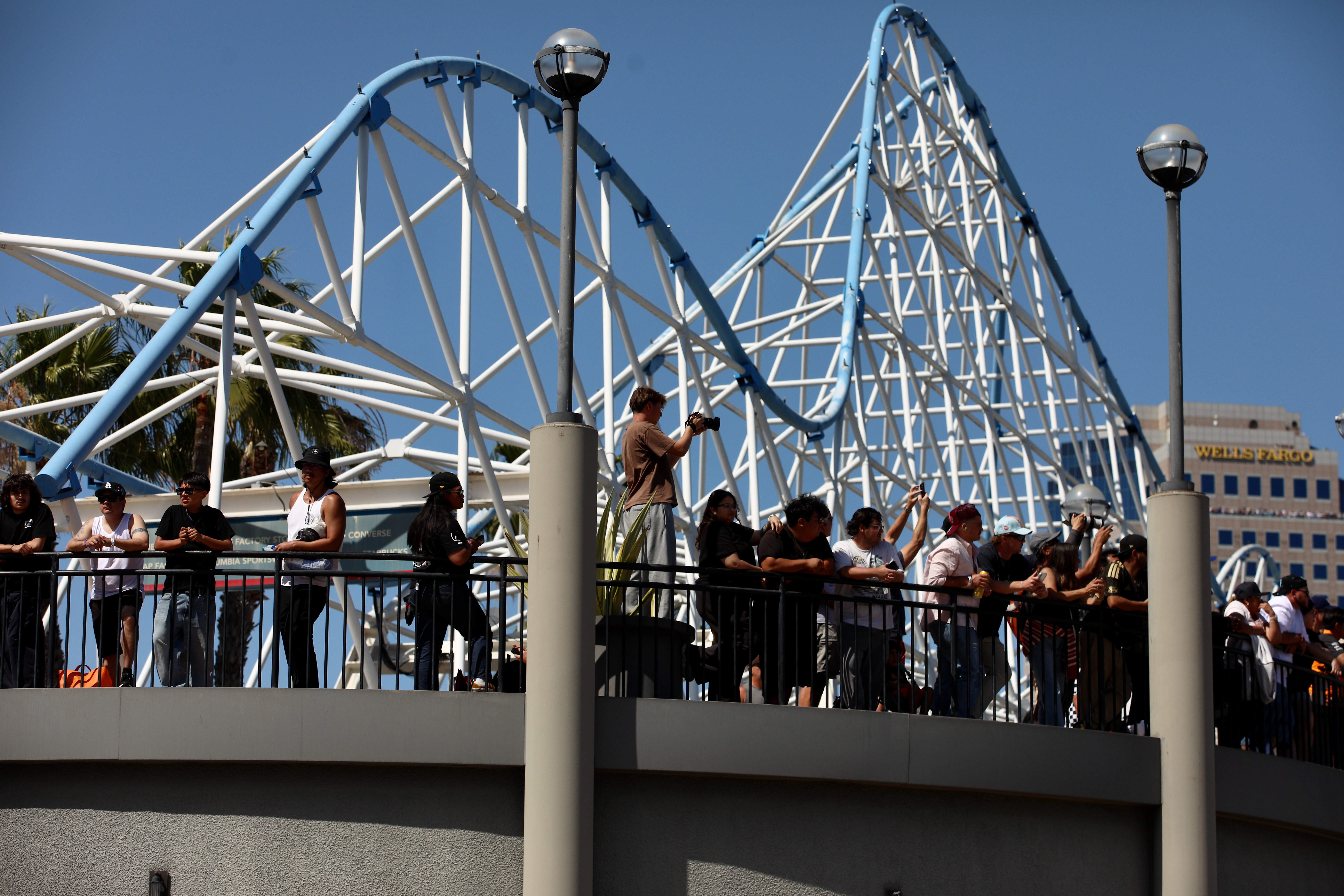 Spectators stake out a vantage point near the Pike Outlets...
