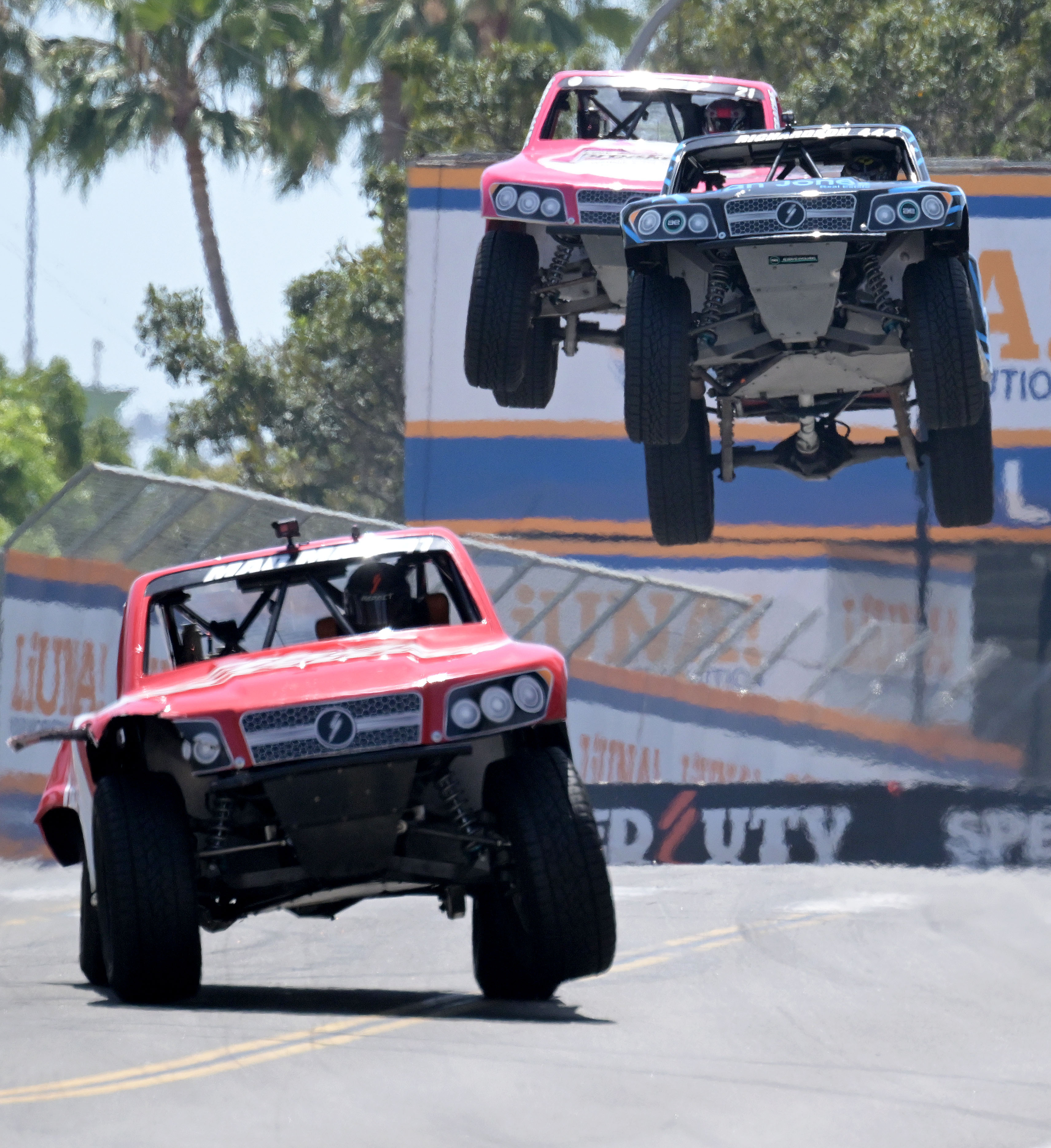 Stadium Super Truck drivers Max Gordon, front left, leads Shaun...