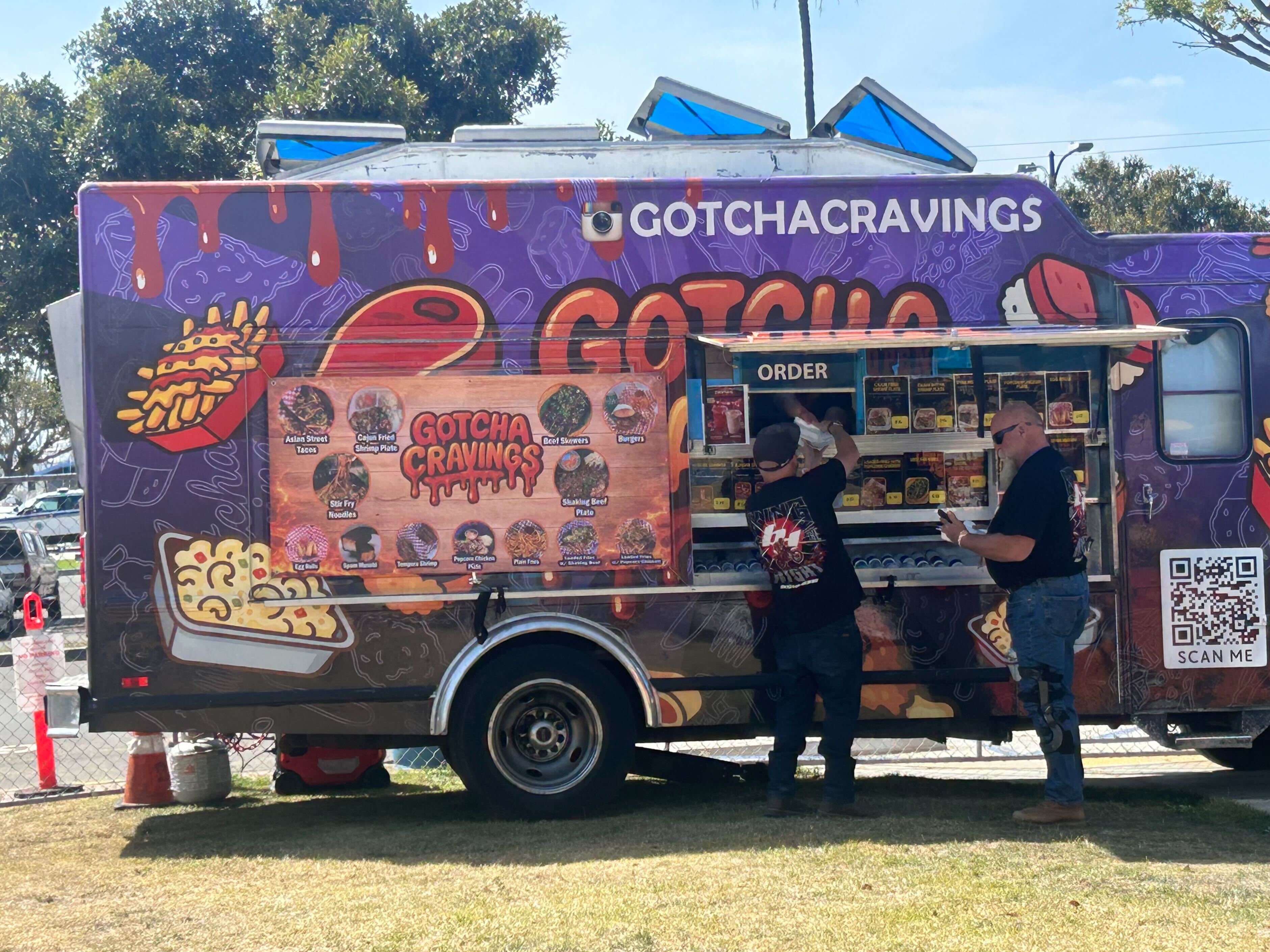 A pair of Grand Prix-goers grab something to eat at...