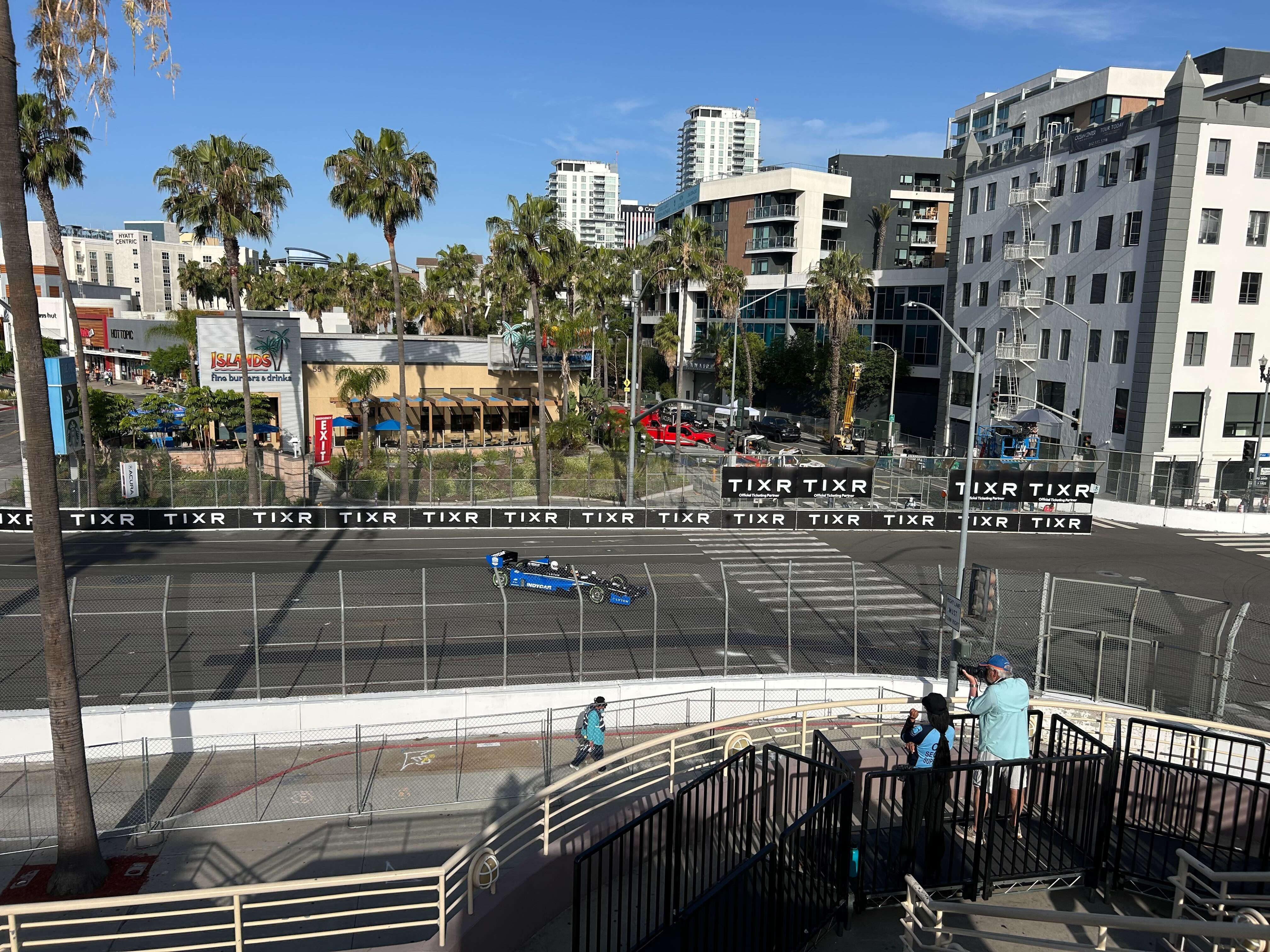 Early bird fans watch race cars zip around the 1.97-mile...