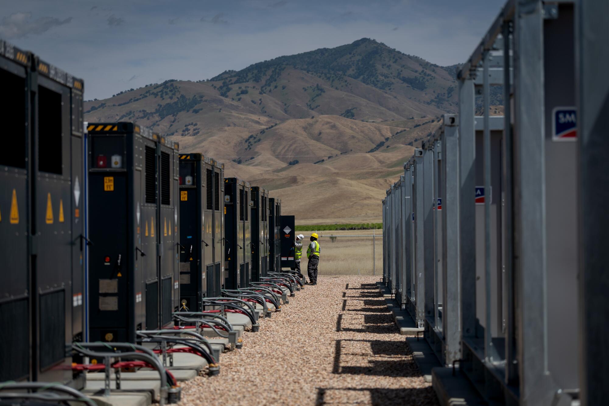Workers inspect the battery storage system during a tour of the Pastoria facilities.