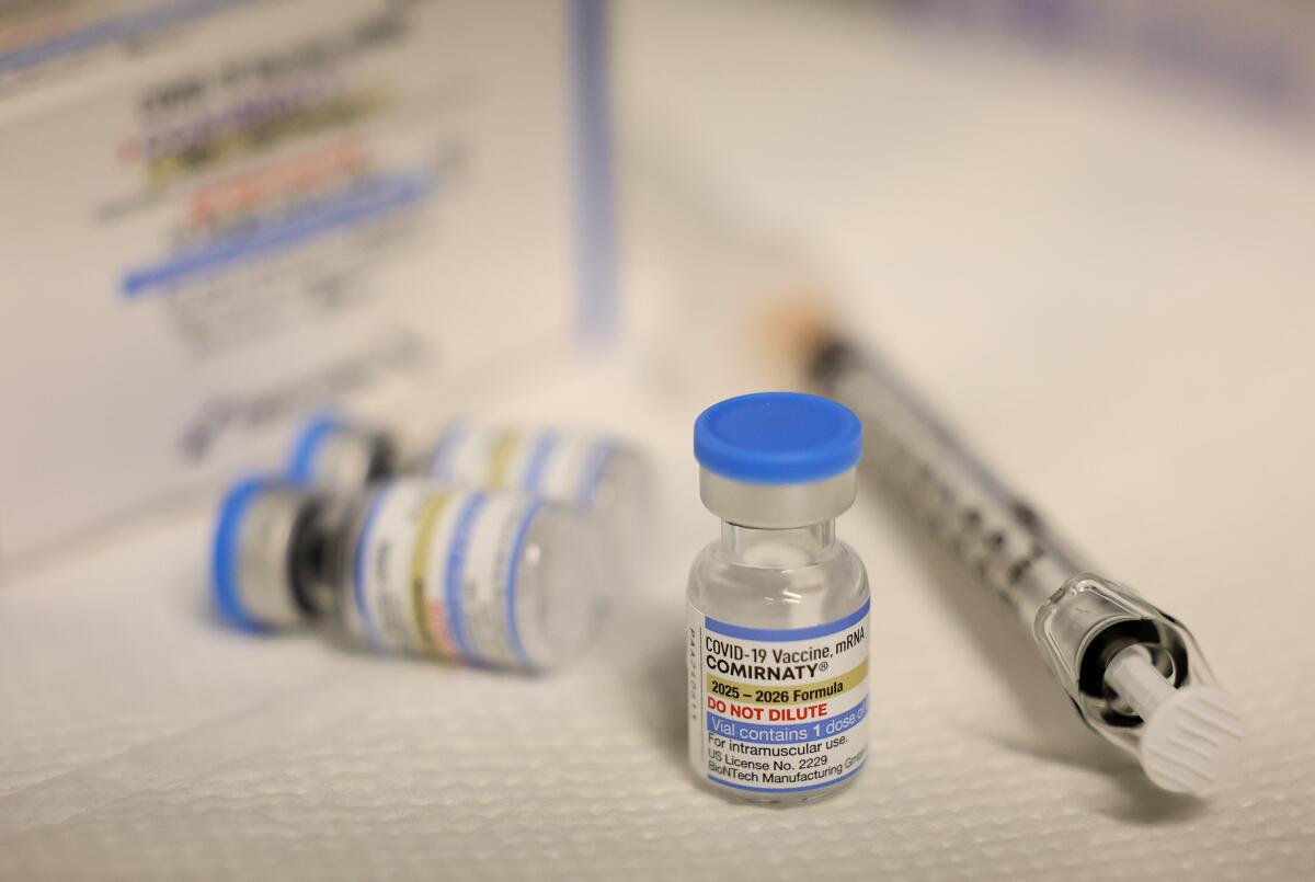 Vials and syringe containing a COVID-19 vaccination.