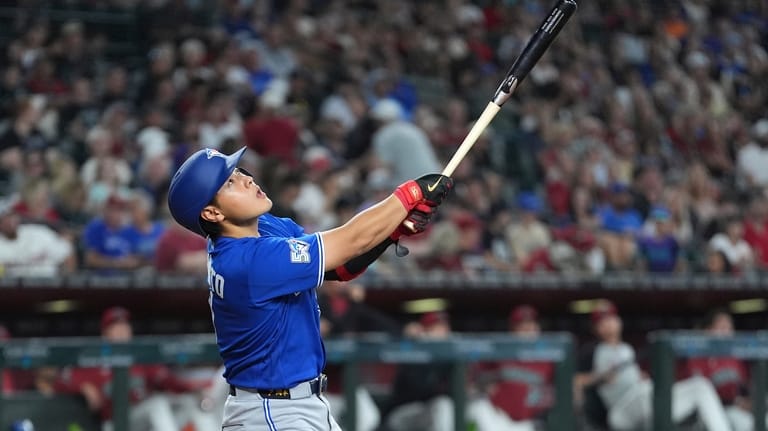 Toronto Blue Jays' Kazuma Okamoto, of Japan, fouls off a...