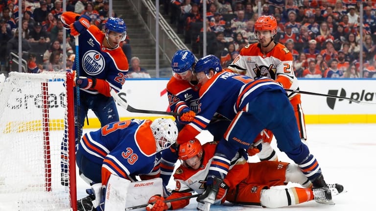 Anaheim Ducks' Troy Terry (19) battles against Edmonton Oilers' goaltender...