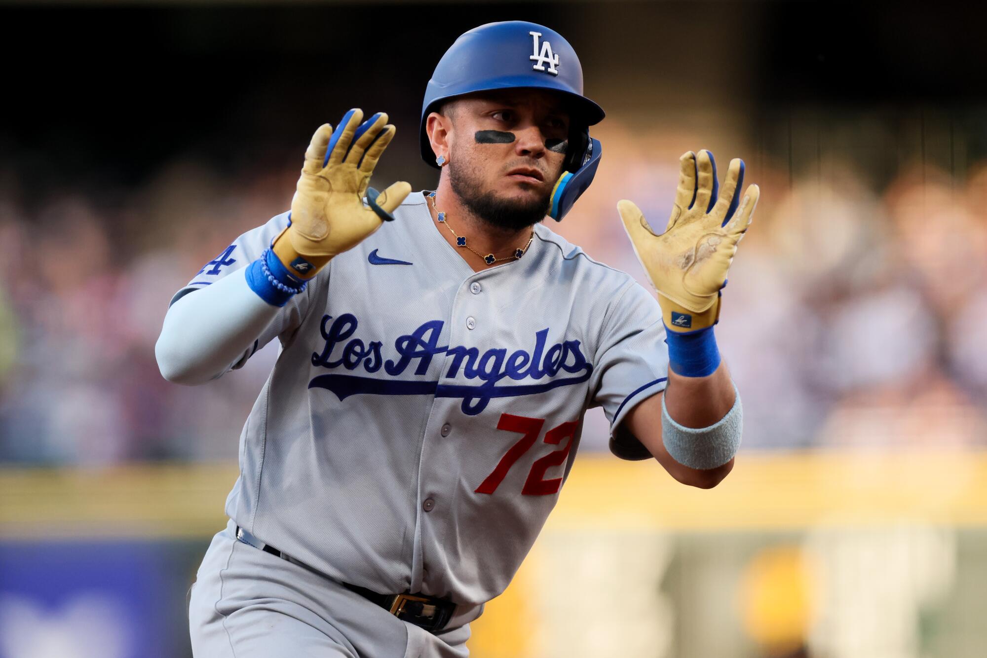 Miguel Rojas celebrates after hitting a home run for the Dodgers in the second inning Monday against the Rockies.