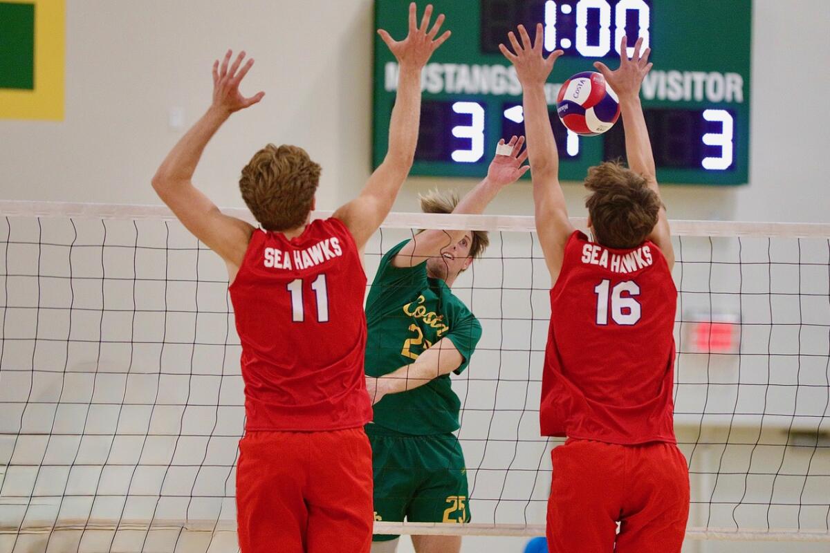 Redondo Union’s Vaughn Flaherty, left, and JR Boice try to block a hit from Mira Costa's Colby Graham.