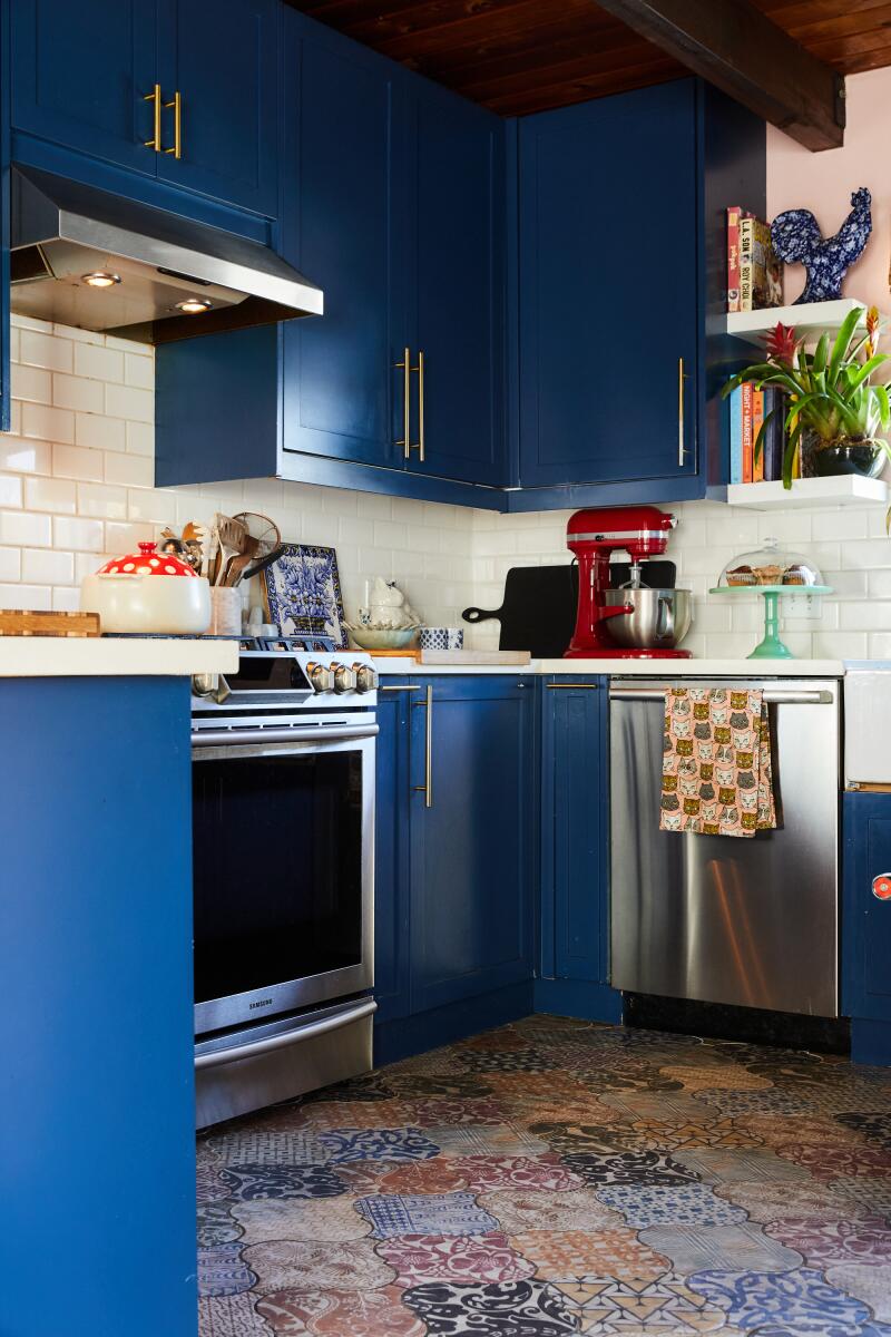 A kitchen with blue cabinets.