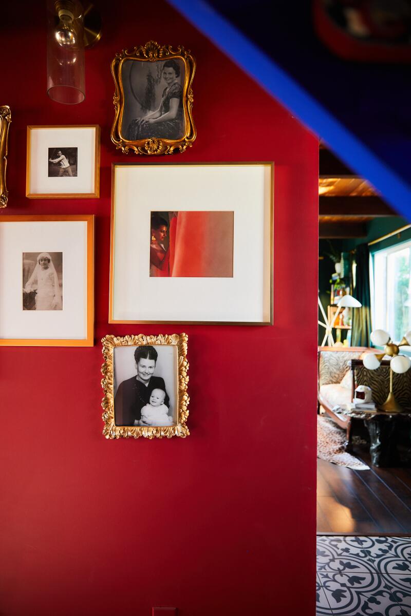 A red wall with photographs.